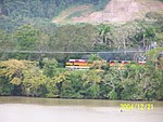 [Panama Canal Railroad alongside canal; major earthworks in the background]