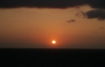 [A beautiful sunrise through hazy and cloudy skies.  This is about 200 nautical miles southeast of Maui.]